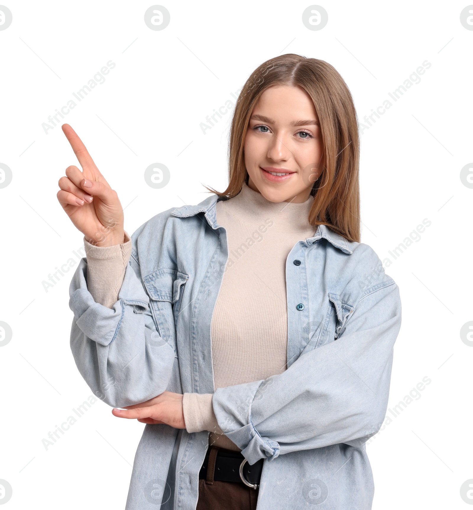 Portrait of smiling teenage girl pointing at something on white background Photo of Portrait of smiling teenage girl pointing at something on white background