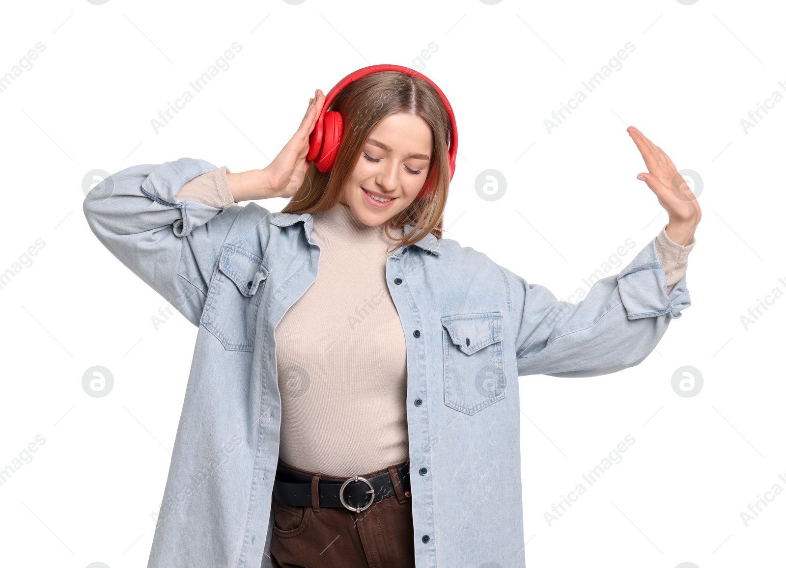 Photo of Smiling teenage girl in headphones listening to music on white background