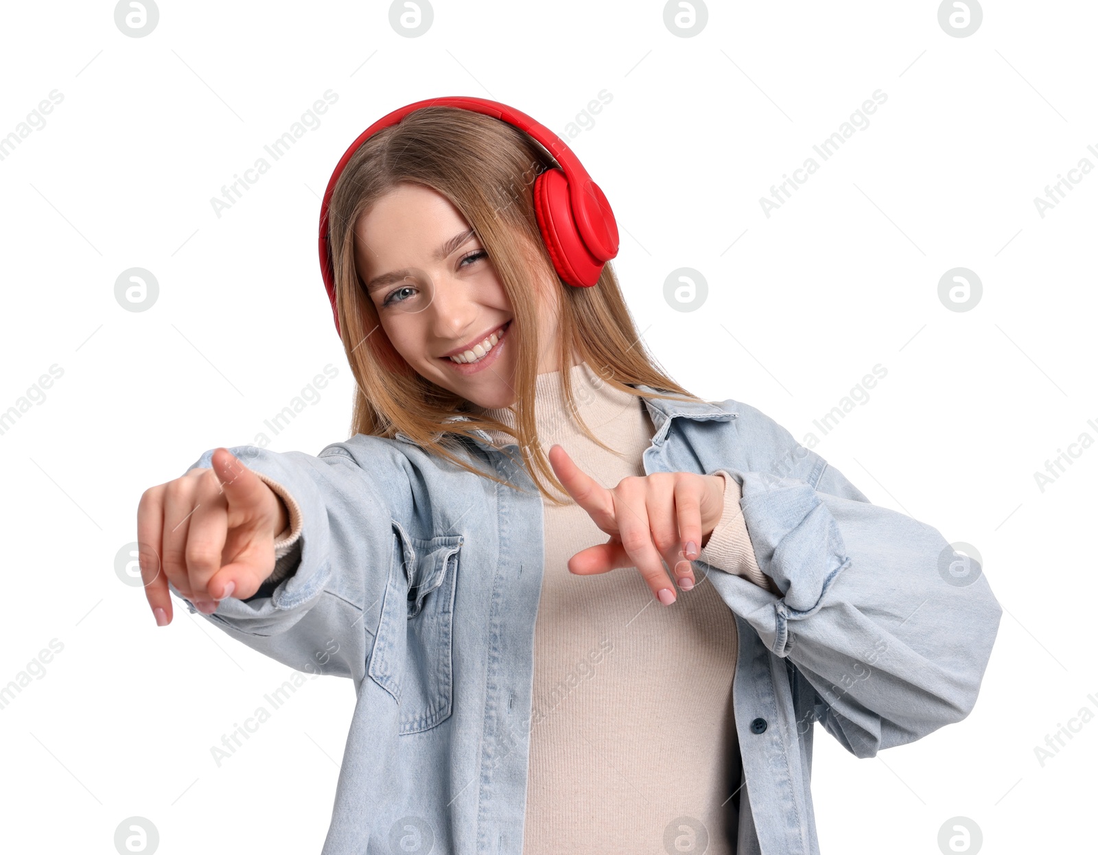Photo of Smiling teenage girl in headphones listening to music on white background