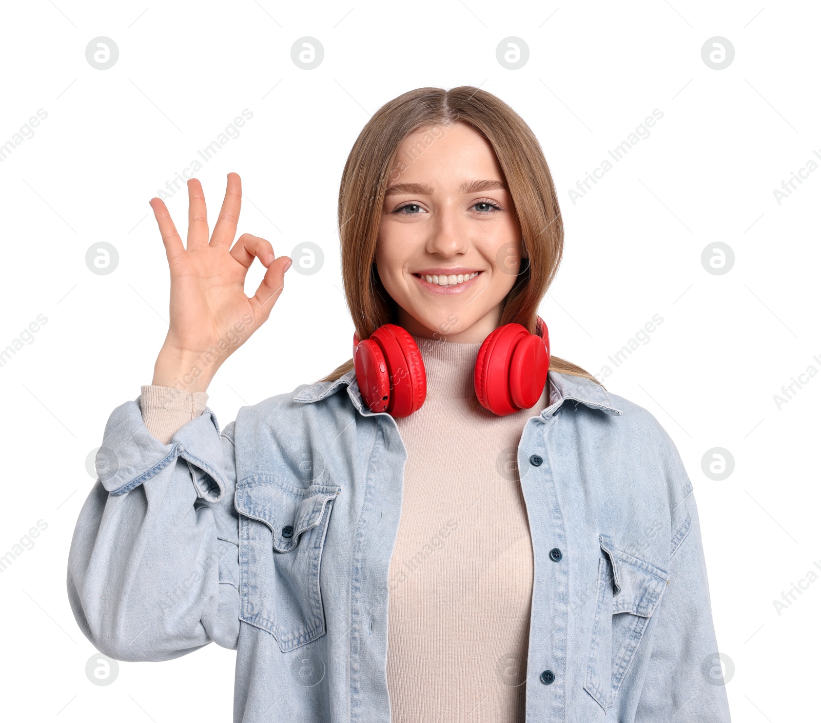 Portrait of smiling teenage girl showing ok gesture on white background Photo of Portrait of smiling teenage girl showing ok gesture on white background