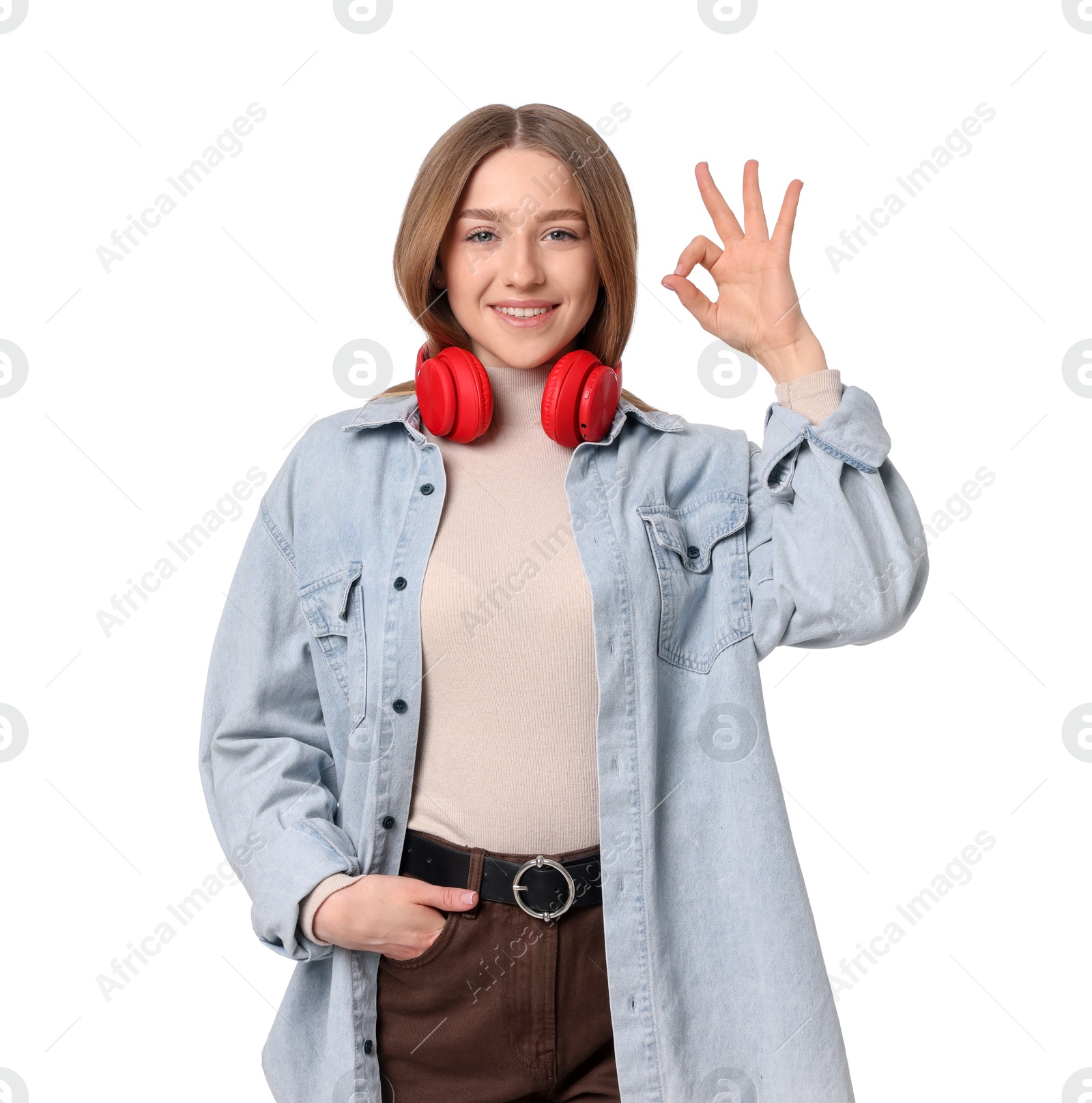 Photo of Portrait of smiling teenage girl showing ok gesture on white background