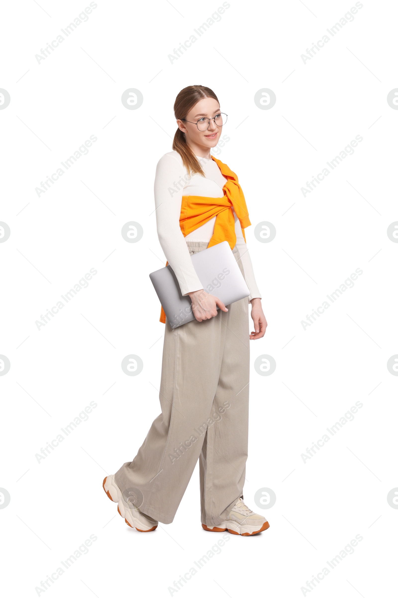 Smiling teenage girl with laptop on white background Photo of Smiling teenage girl with laptop on white background