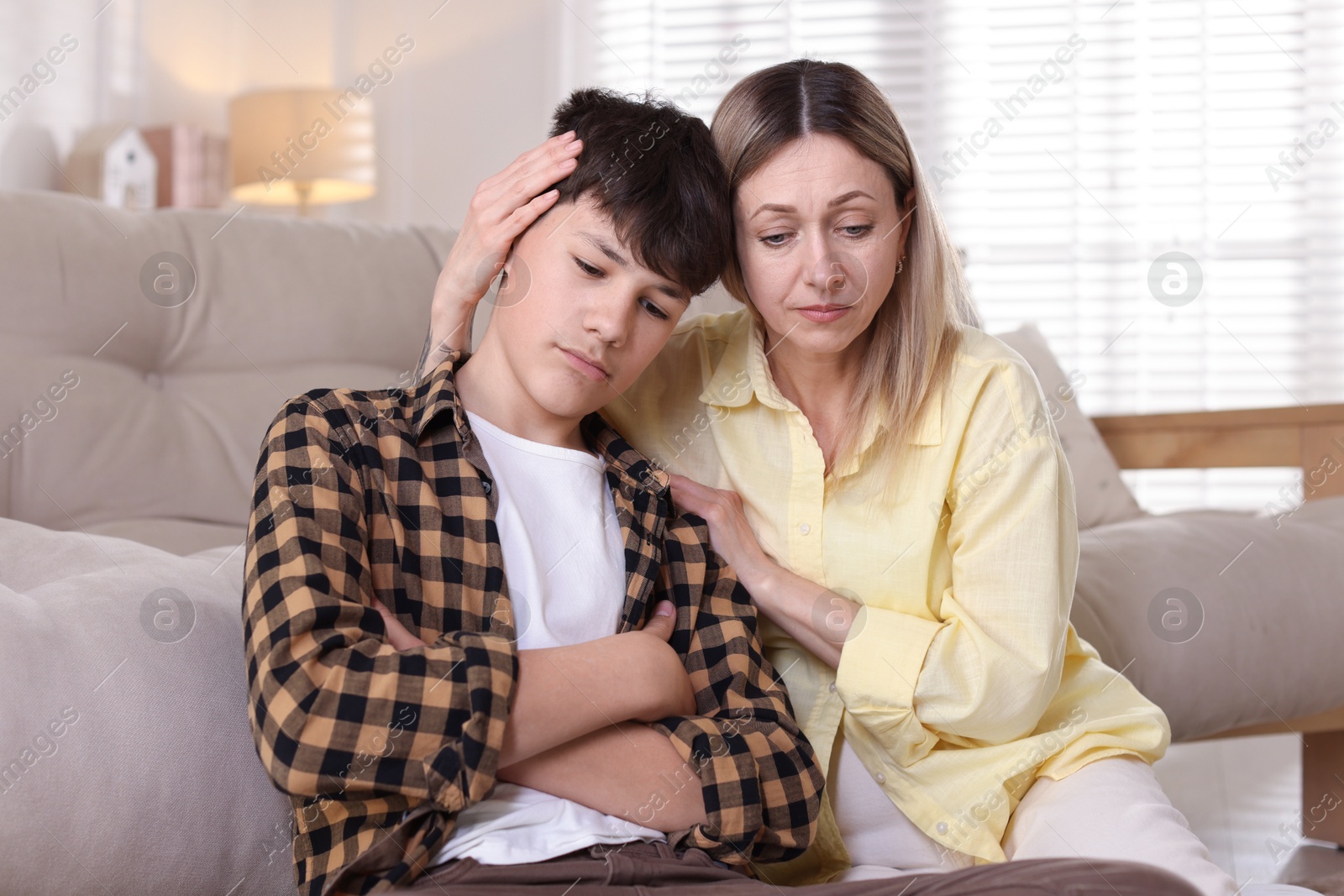 Mother consoling her upset son at home Photo of Mother consoling her upset son at home