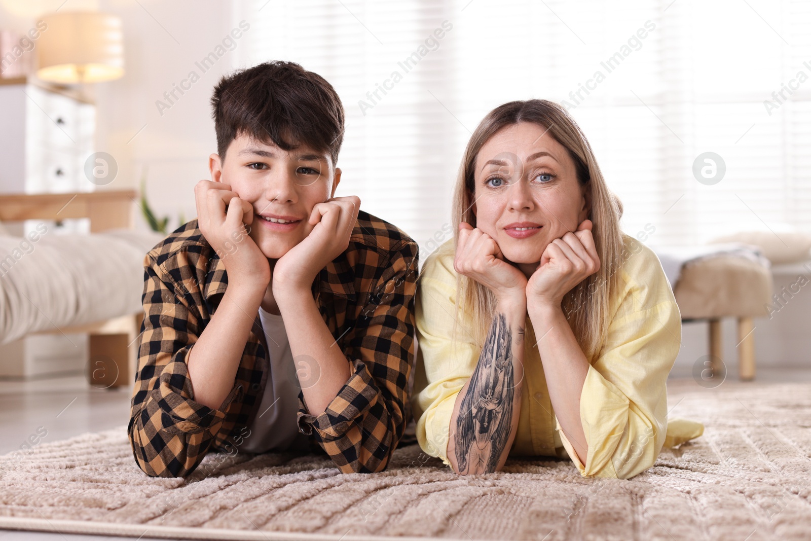 Mother and her son on floor at home Photo of Mother and her son on floor at home