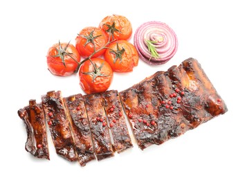 Photo of Delicious roasted pork ribs with tomatoes and onion isolated on white, top view