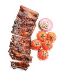 Photo of Delicious roasted pork ribs with tomatoes and onion isolated on white, top view