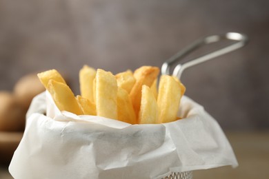 Photo of Tasty french fries on grey background, closeup