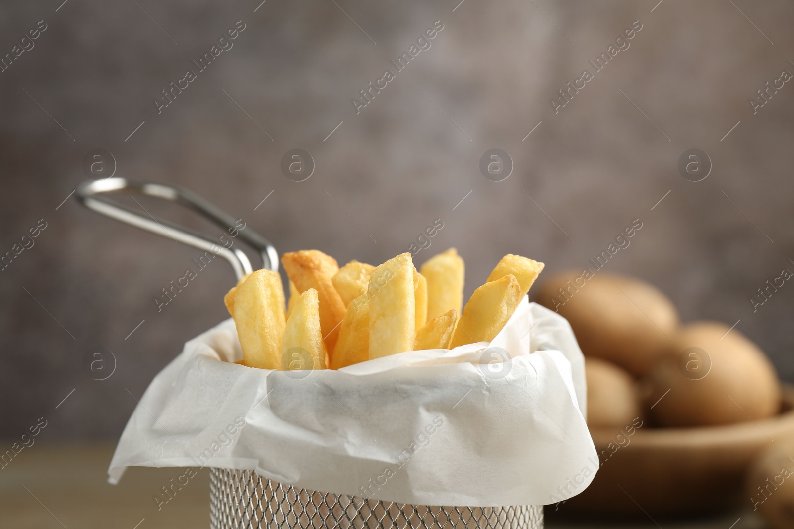 Tasty french fries on grey background, closeup. Space for text Photo of Tasty french fries on grey background, closeup. Space for text