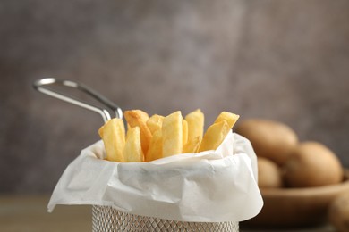 Photo of Tasty french fries on grey background, closeup. Space for text