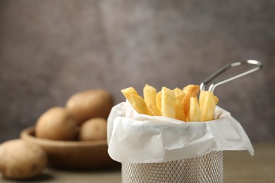 Photo of Tasty french fries on grey background, closeup. Space for text