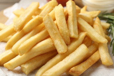 Photo of Fresh tasty french fries on table, closeup
