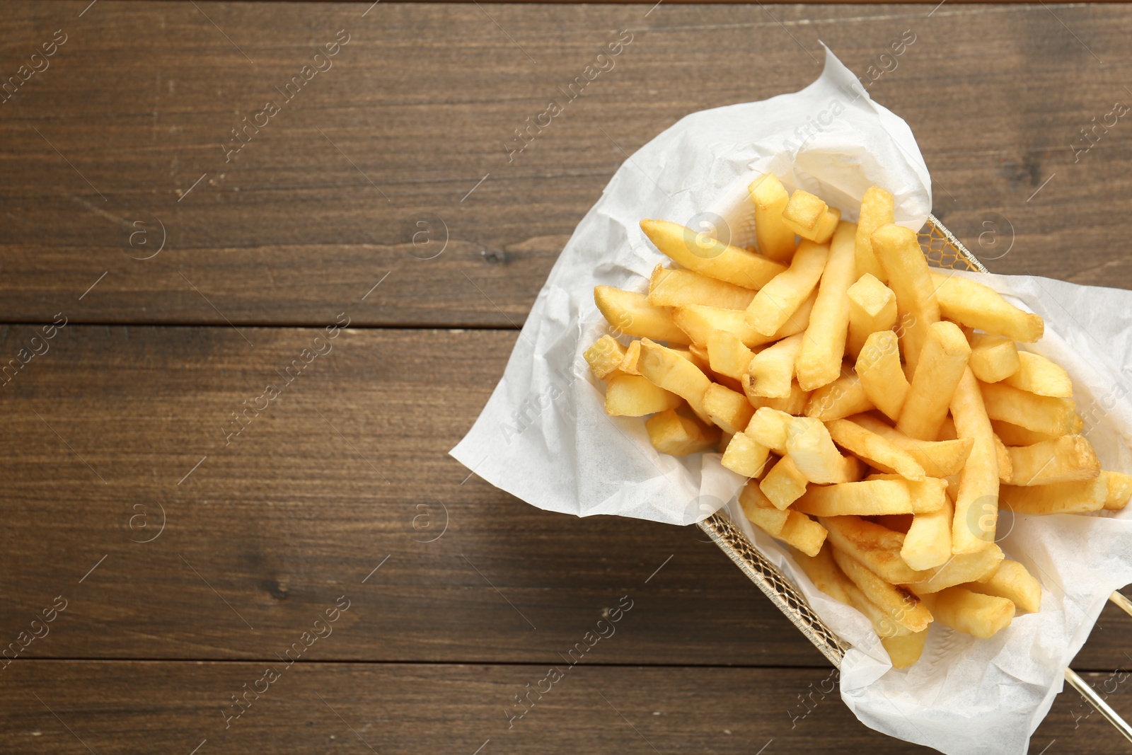 Tasty french fries on wooden table, top view. Space for text Photo of Tasty french fries on wooden table, top view. Space for text