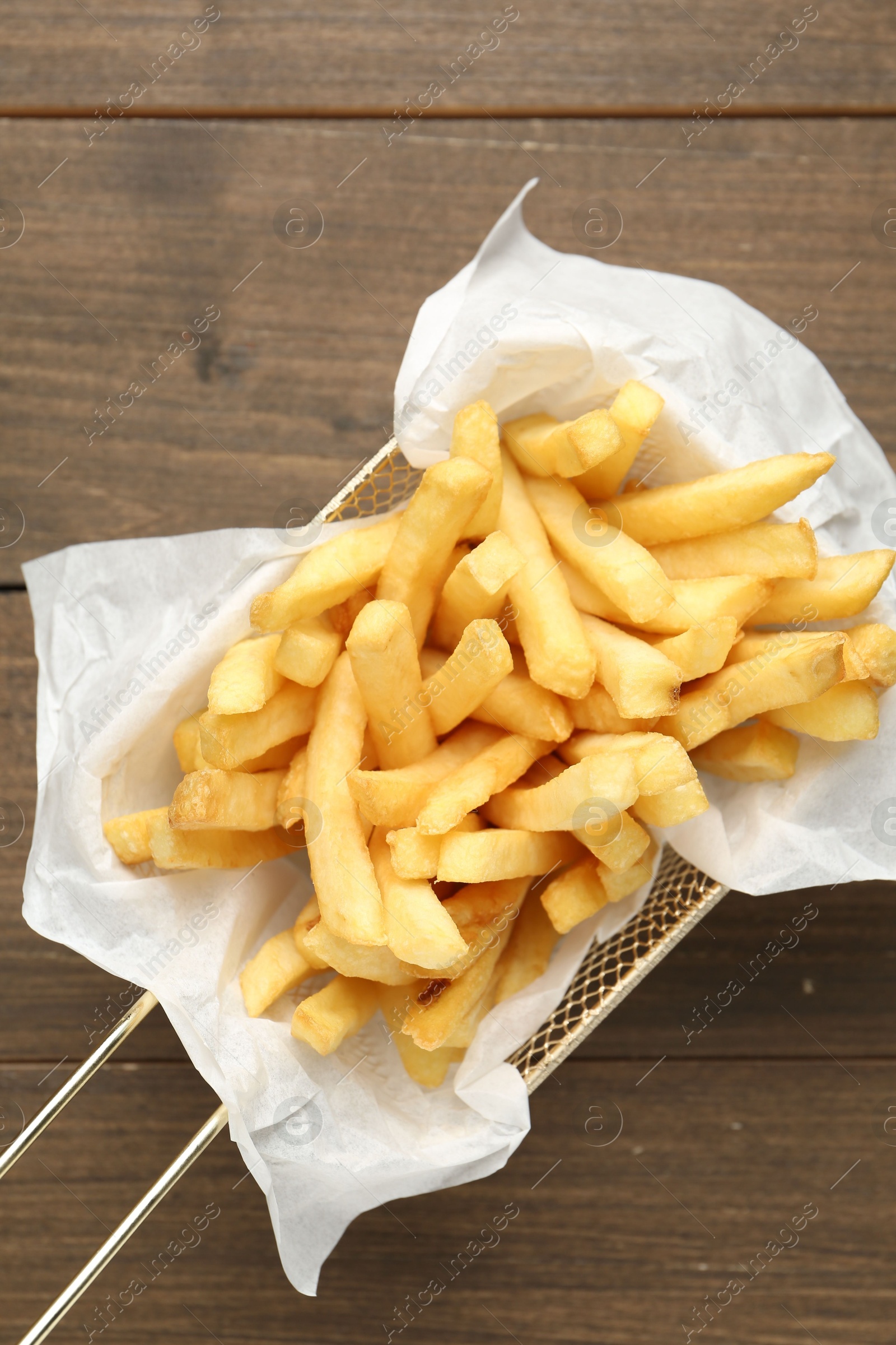Tasty french fries on wooden table, top view Photo of Tasty french fries on wooden table, top view