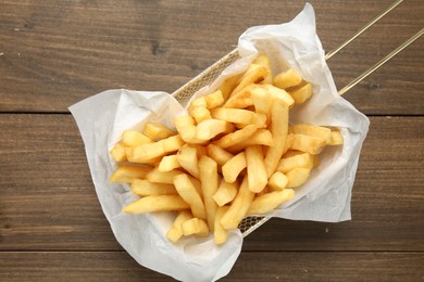 Photo of Tasty french fries on wooden table, top view