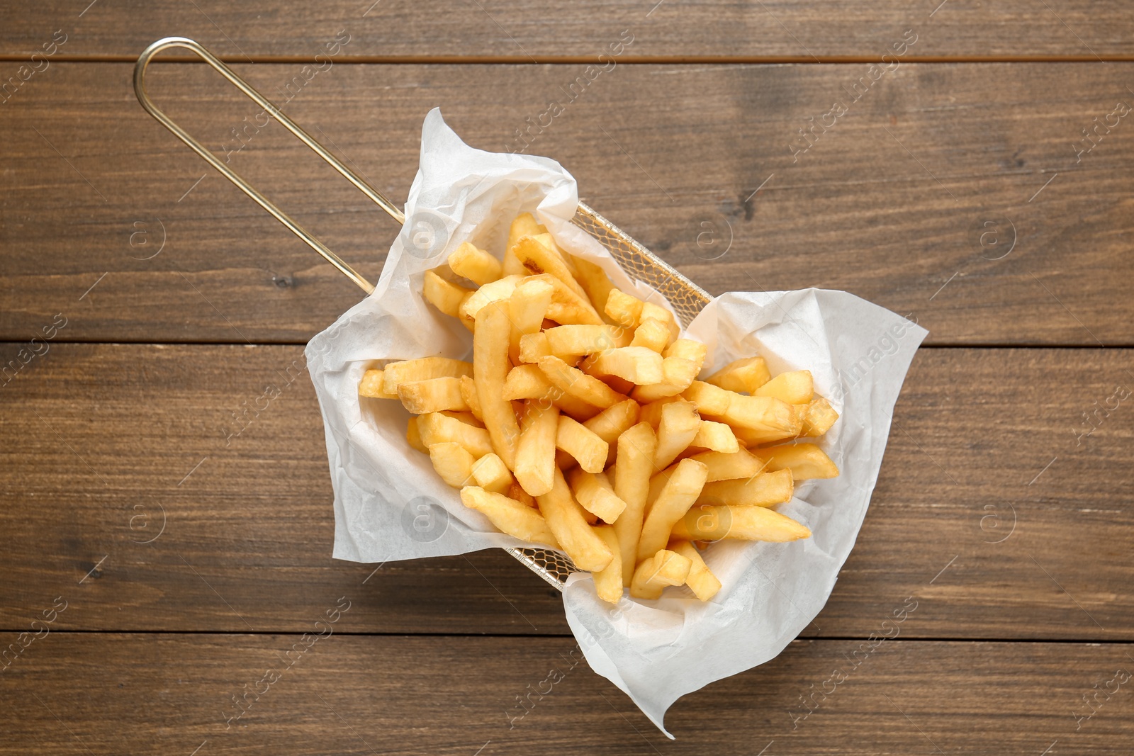 Tasty french fries on wooden table, top view Photo of Tasty french fries on wooden table, top view