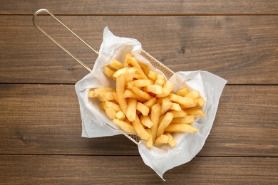 Photo of Tasty french fries on wooden table, top view