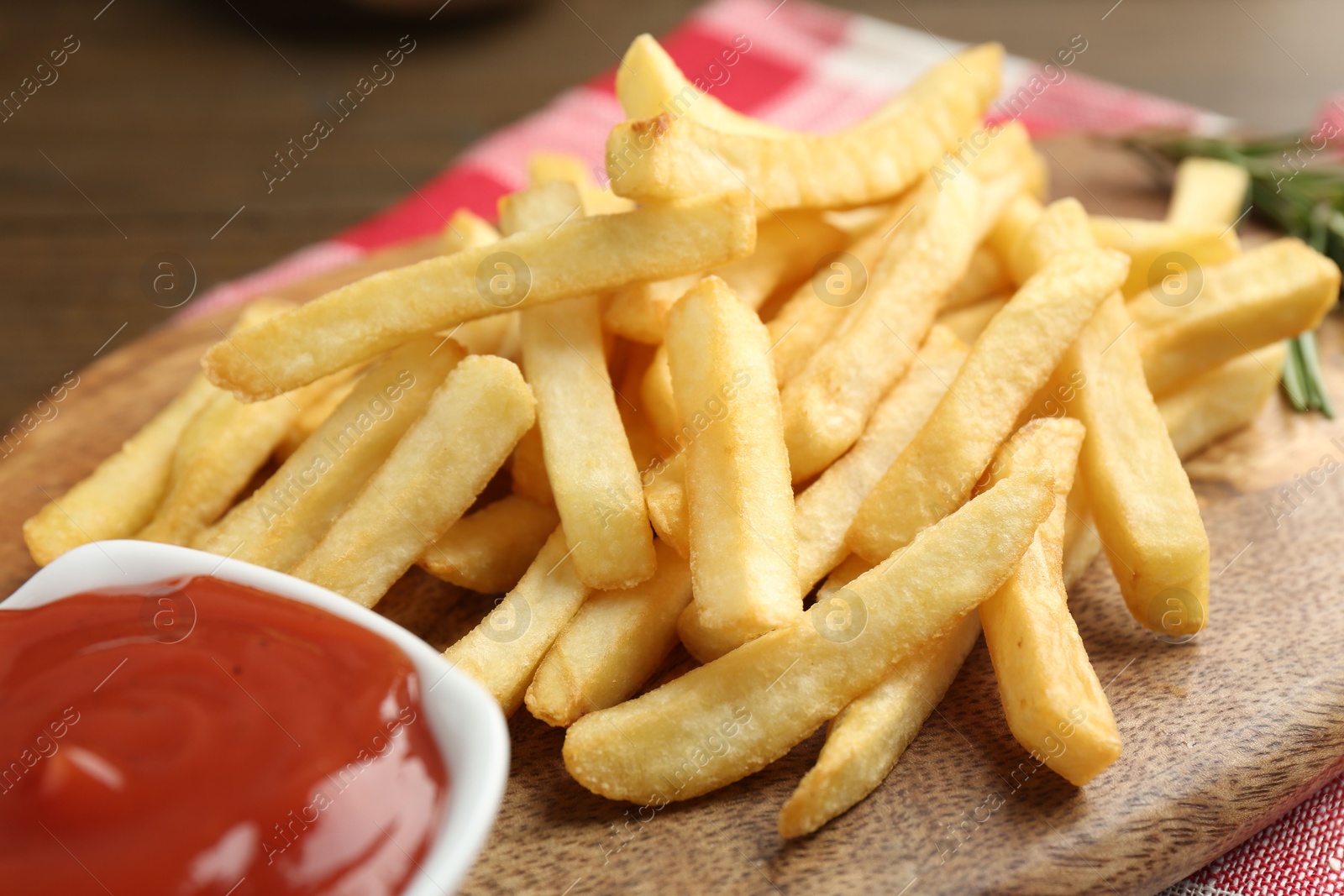 Tasty french fries with ketchup on wooden table Photo of Tasty french fries with ketchup on wooden table