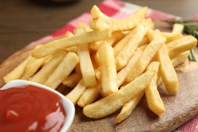 Photo of Tasty french fries with ketchup on wooden table
