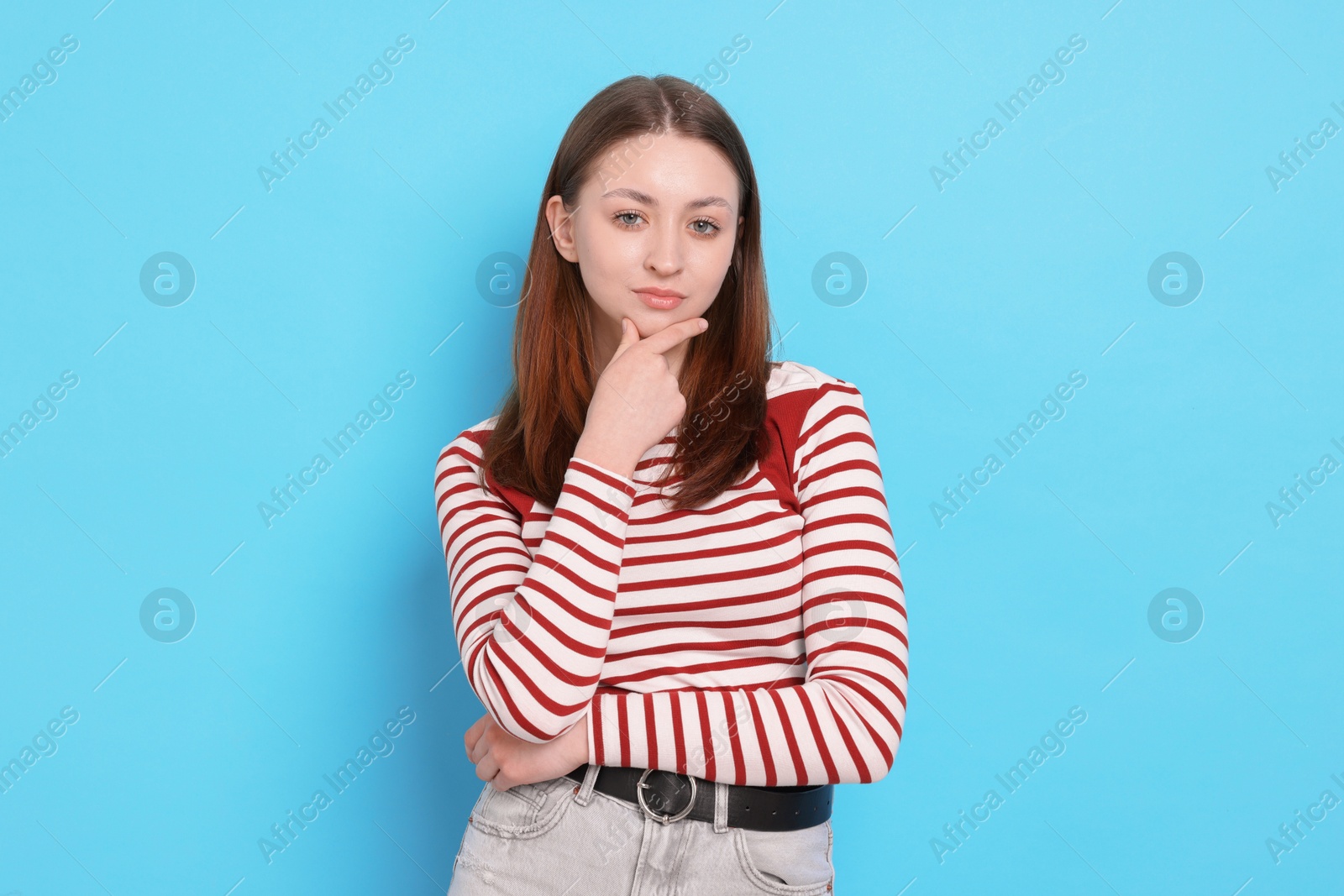Photo of Portrait of teenage girl on light blue background