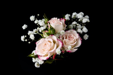 Photo of Woman holding bouquet with beautiful gypsophila and roses on black background, closeup