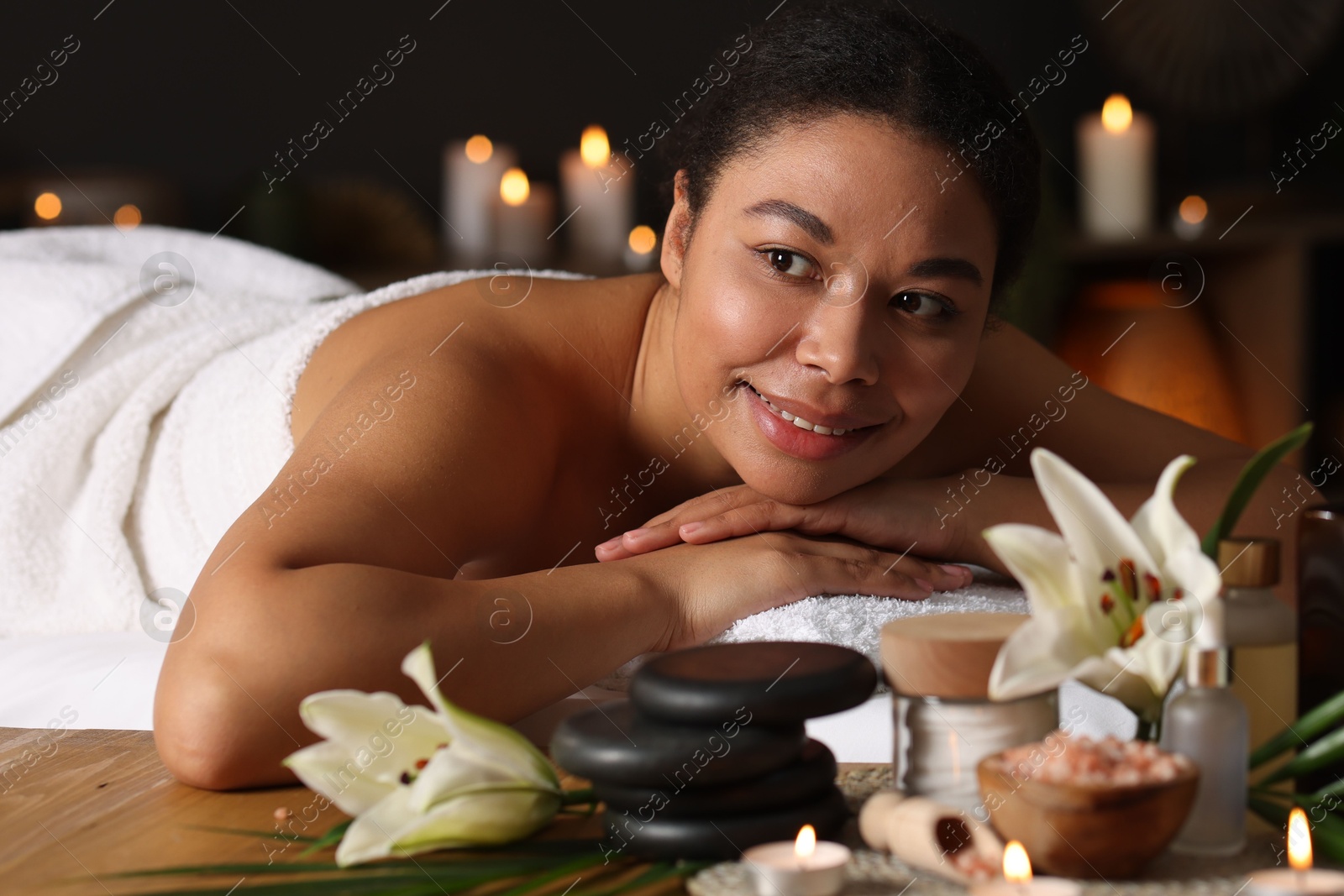 Beautiful woman relaxing on massage couch in spa salon Photo of Beautiful woman relaxing on massage couch in spa salon