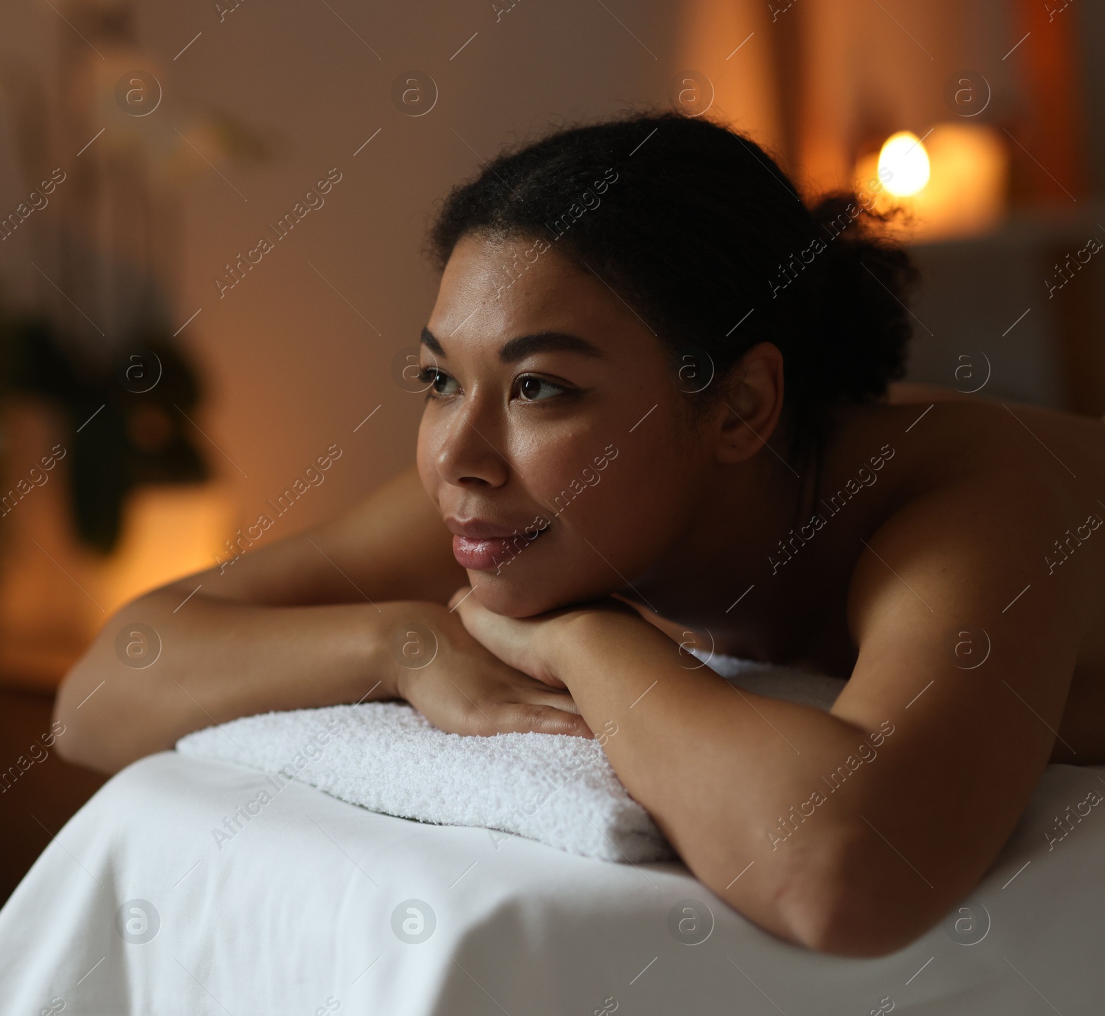 Beautiful woman relaxing on massage couch in spa salon Photo of Beautiful woman relaxing on massage couch in spa salon