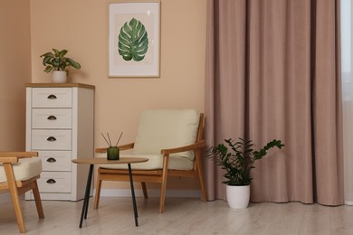 Photo of Stylish room interior with comfortable armchairs and beautiful window curtains