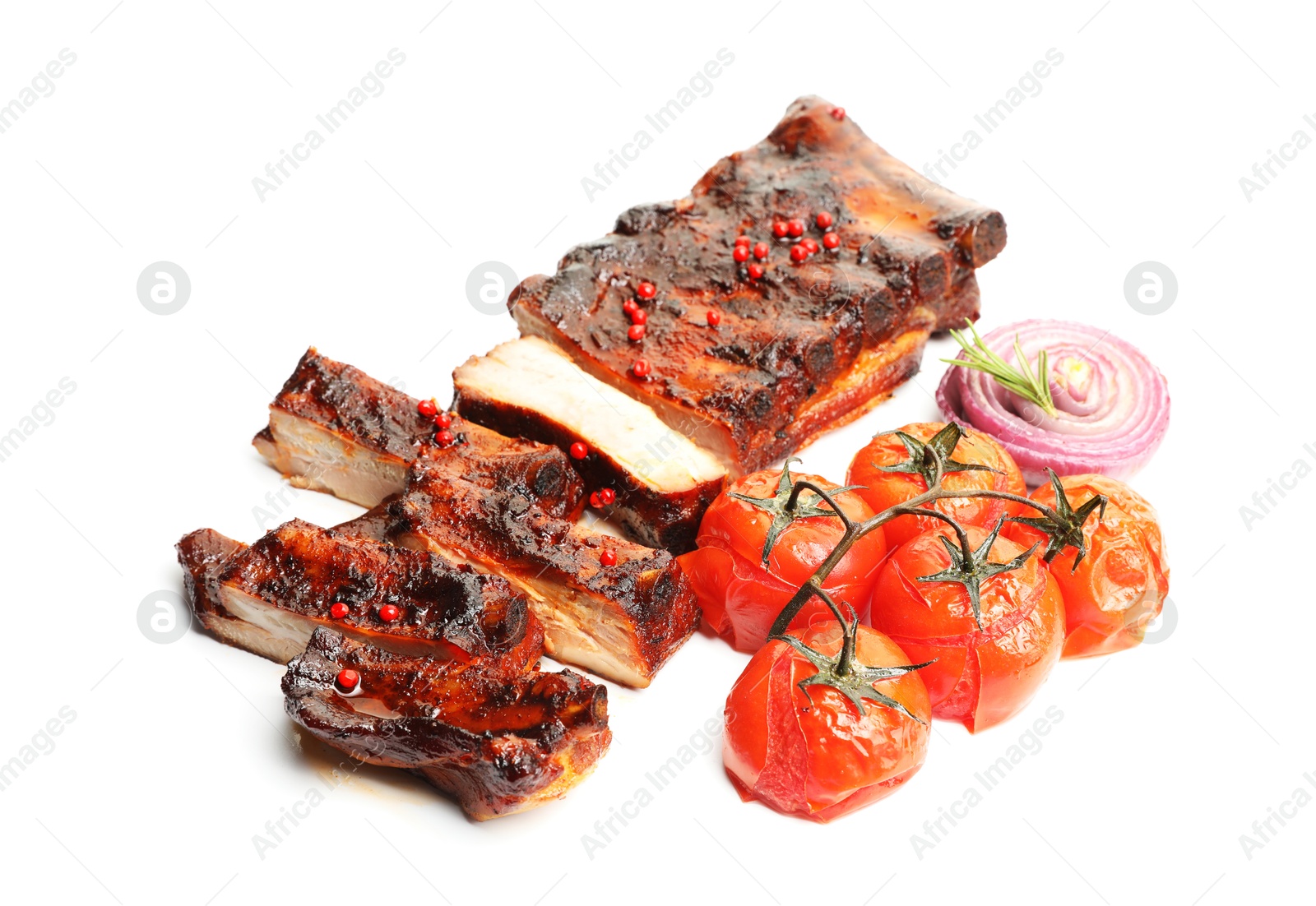 Delicious roasted pork ribs with tomatoes and onion isolated on white Photo of Delicious roasted pork ribs with tomatoes and onion isolated on white