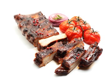 Photo of Delicious roasted pork ribs with tomatoes and onion isolated on white