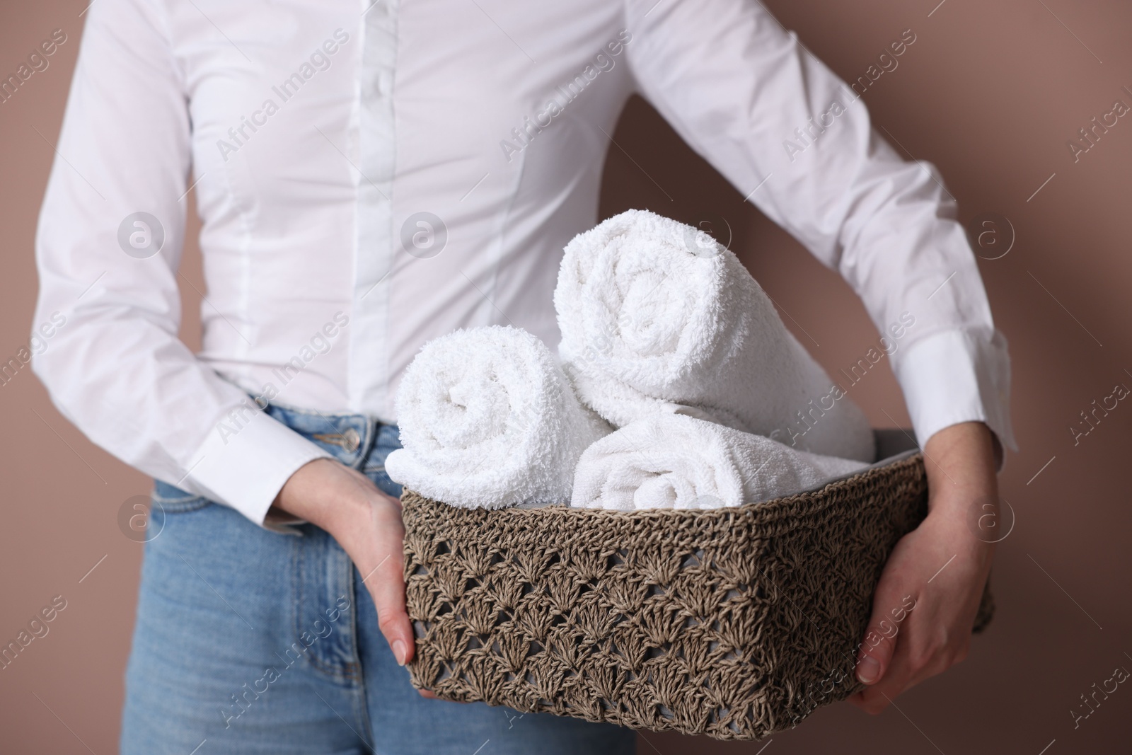 Woman with clean towels on beige background, closeup Photo of Woman with clean towels on beige background, closeup