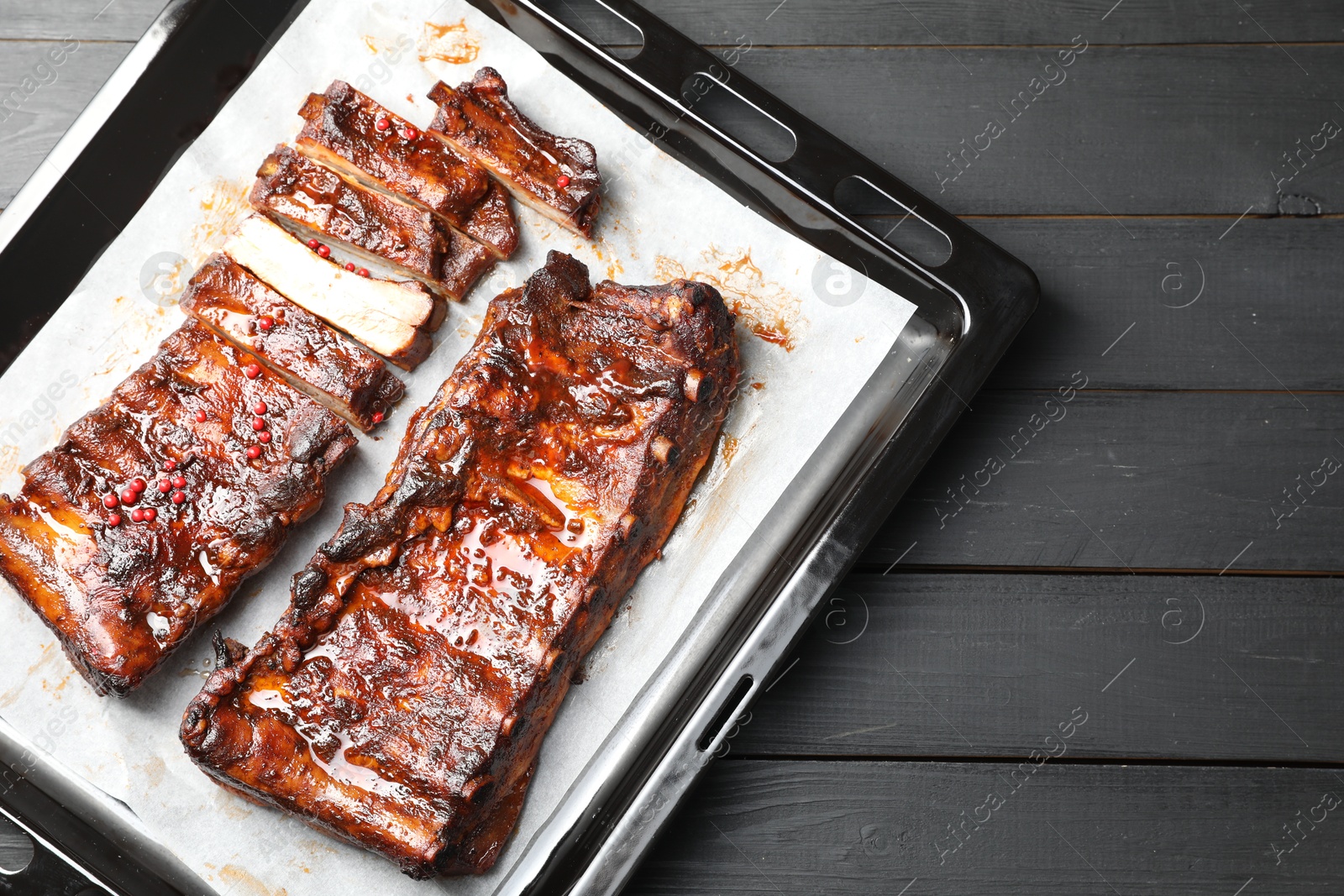 Delicious spare ribs on grey wooden table, top view Photo of Delicious spare ribs on grey wooden table, top view