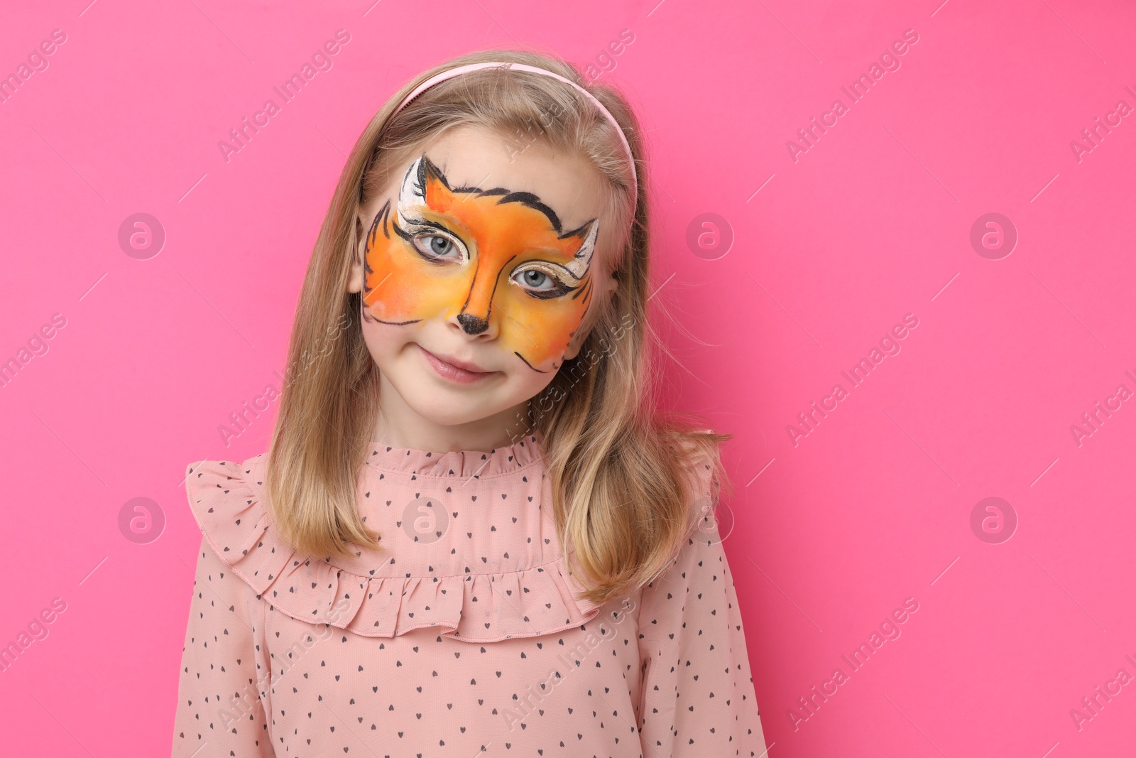 Cute girl with fox face painting on pink background, space for text Photo of Cute girl with fox face painting on pink background, space for text