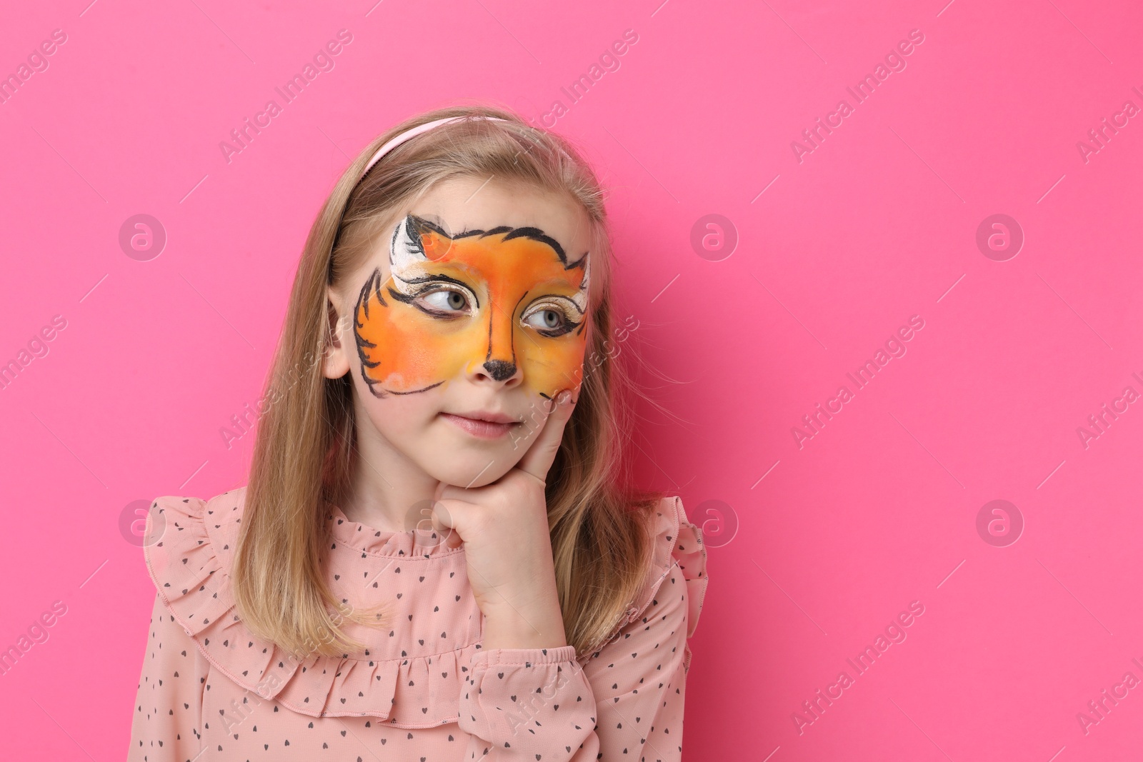 Cute girl with fox face painting on pink background, space for text Photo of Cute girl with fox face painting on pink background, space for text