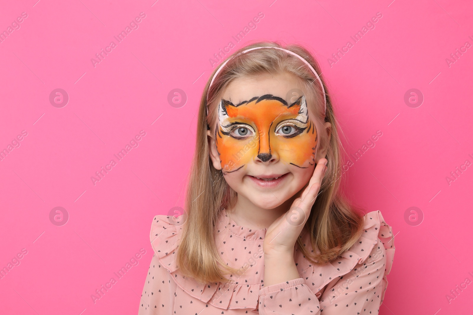 Cute girl with fox face painting on pink background, space for text Photo of Cute girl with fox face painting on pink background, space for text