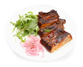 Photo of Delicious spare ribs, onion and arugula isolated on white
