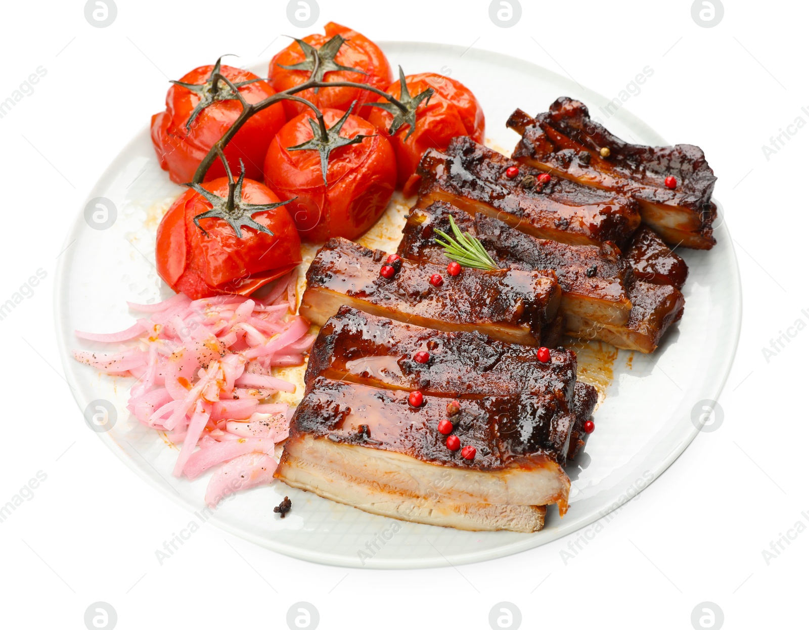 Delicious spare ribs, onion and sun dried tomatoes isolated on white Photo of Delicious spare ribs, onion and sun dried tomatoes isolated on white