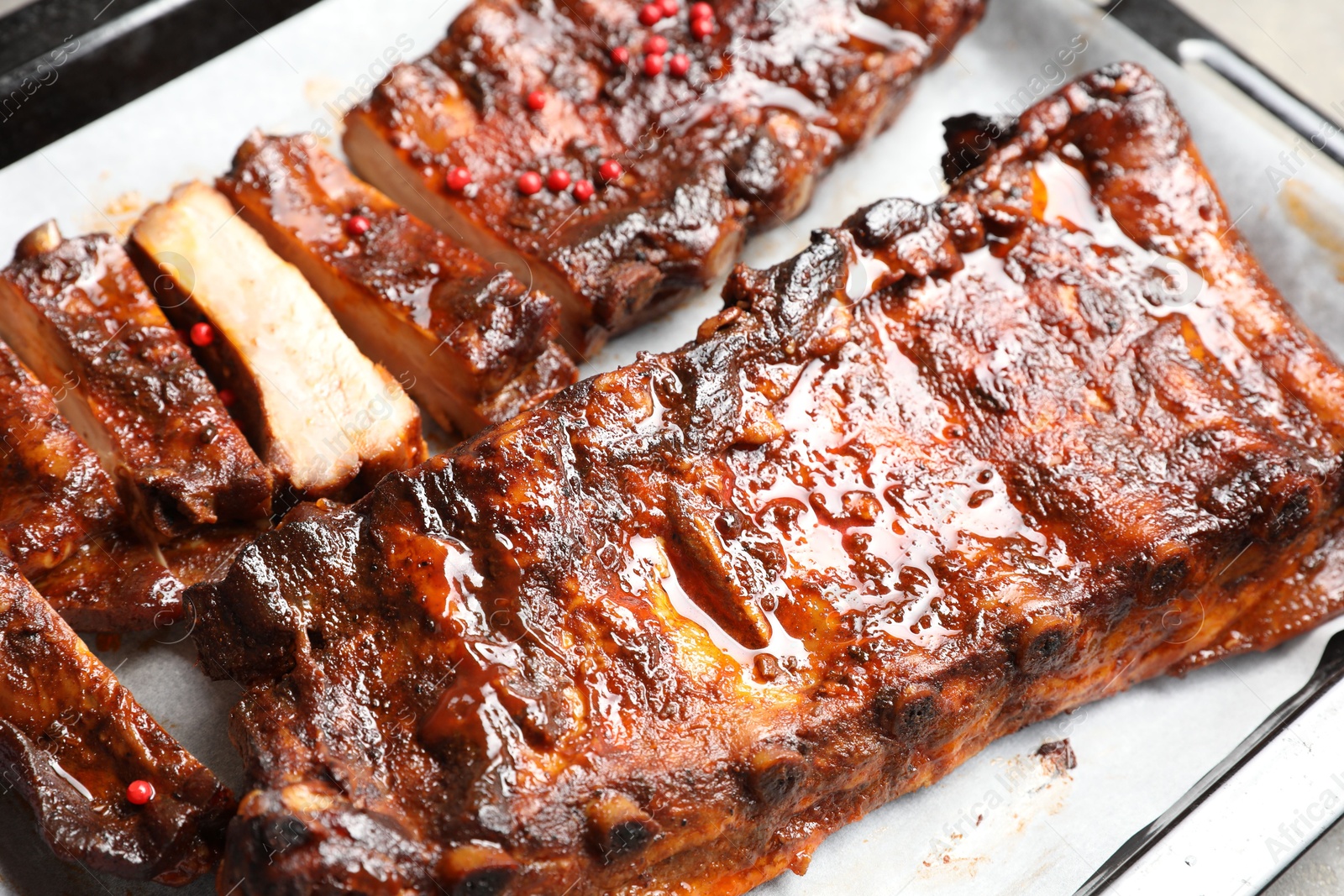 Delicious spare ribs on baking tray, closeup Photo of Delicious spare ribs on baking tray, closeup