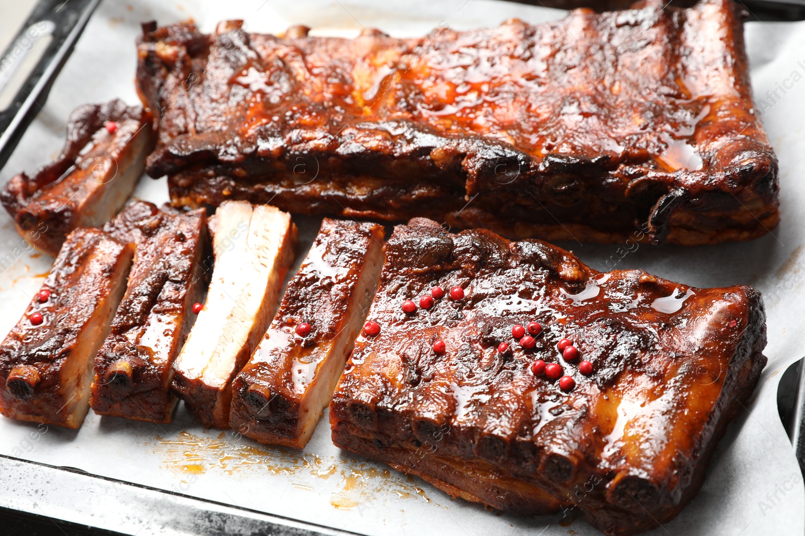 Delicious spare ribs on baking tray, closeup Photo of Delicious spare ribs on baking tray, closeup