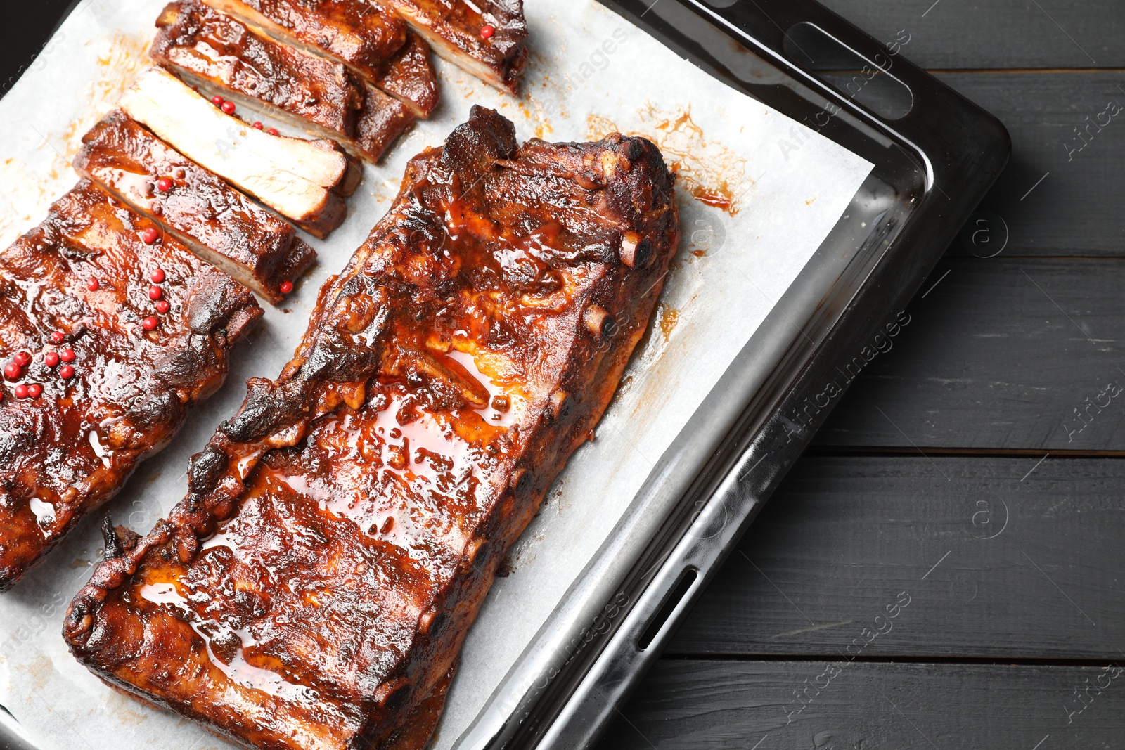 Delicious spare ribs on grey wooden table, top view Photo of Delicious spare ribs on grey wooden table, top view