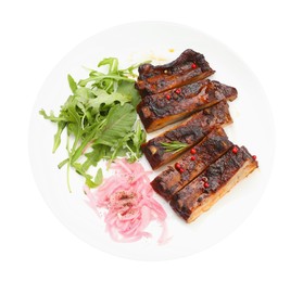 Photo of Delicious pork ribs, arugula and onion isolated on white, top view