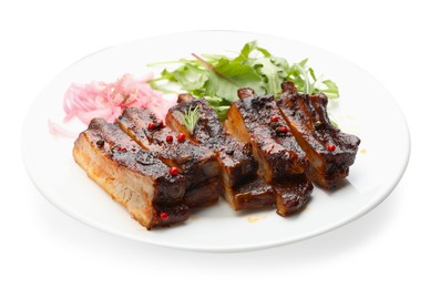 Photo of Delicious pork ribs, arugula and onion isolated on white