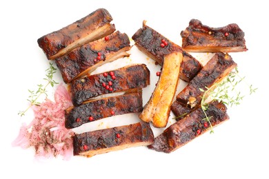 Photo of Delicious pork ribs, thyme and onion isolated on white, top view