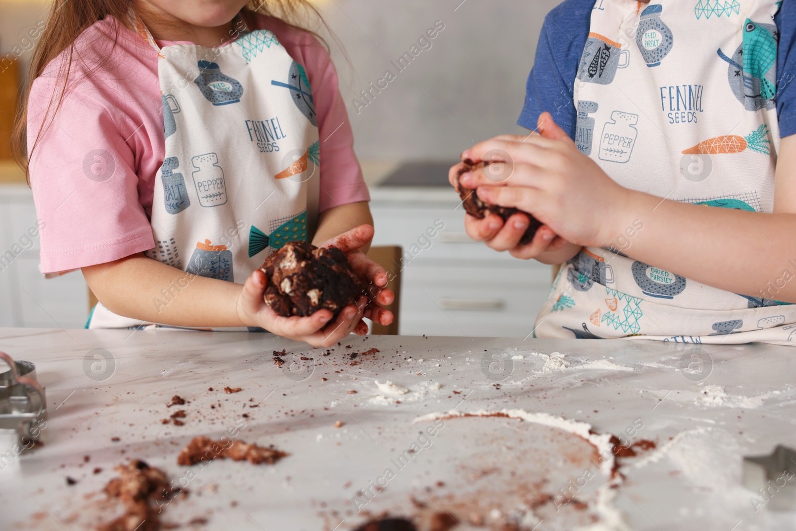 Cooking recipe. Little children making cookie dough at table in kitchen, closeup Photo of Cooking recipe. Little children making cookie dough at table in kitchen, closeup