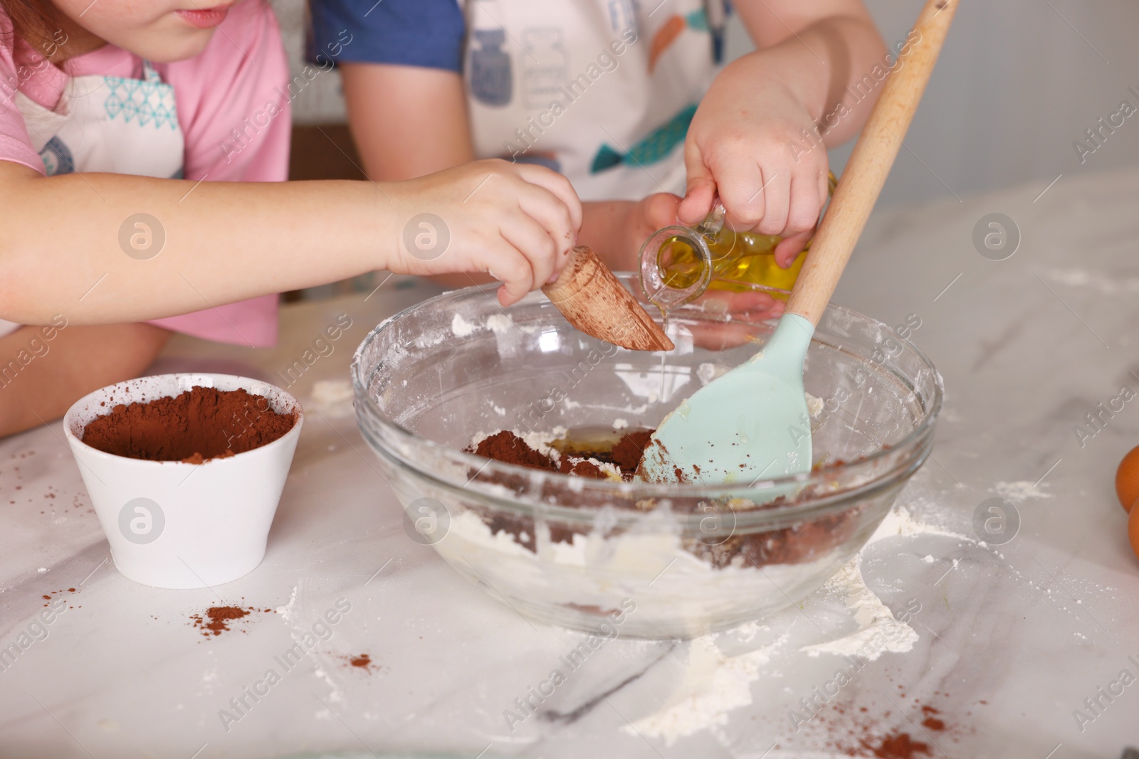Cooking recipe. Cute children making dough for cookies at table in kitchen, closeup Photo of Cooking recipe. Cute children making dough for cookies at table in kitchen, closeup