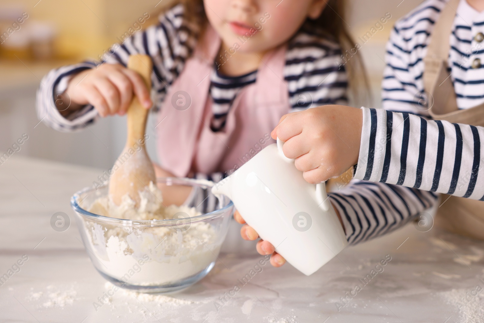 Cooking recipe. Cute children making dough for cookies at table in kitchen, closeup Photo of Cooking recipe. Cute children making dough for cookies at table in kitchen, closeup