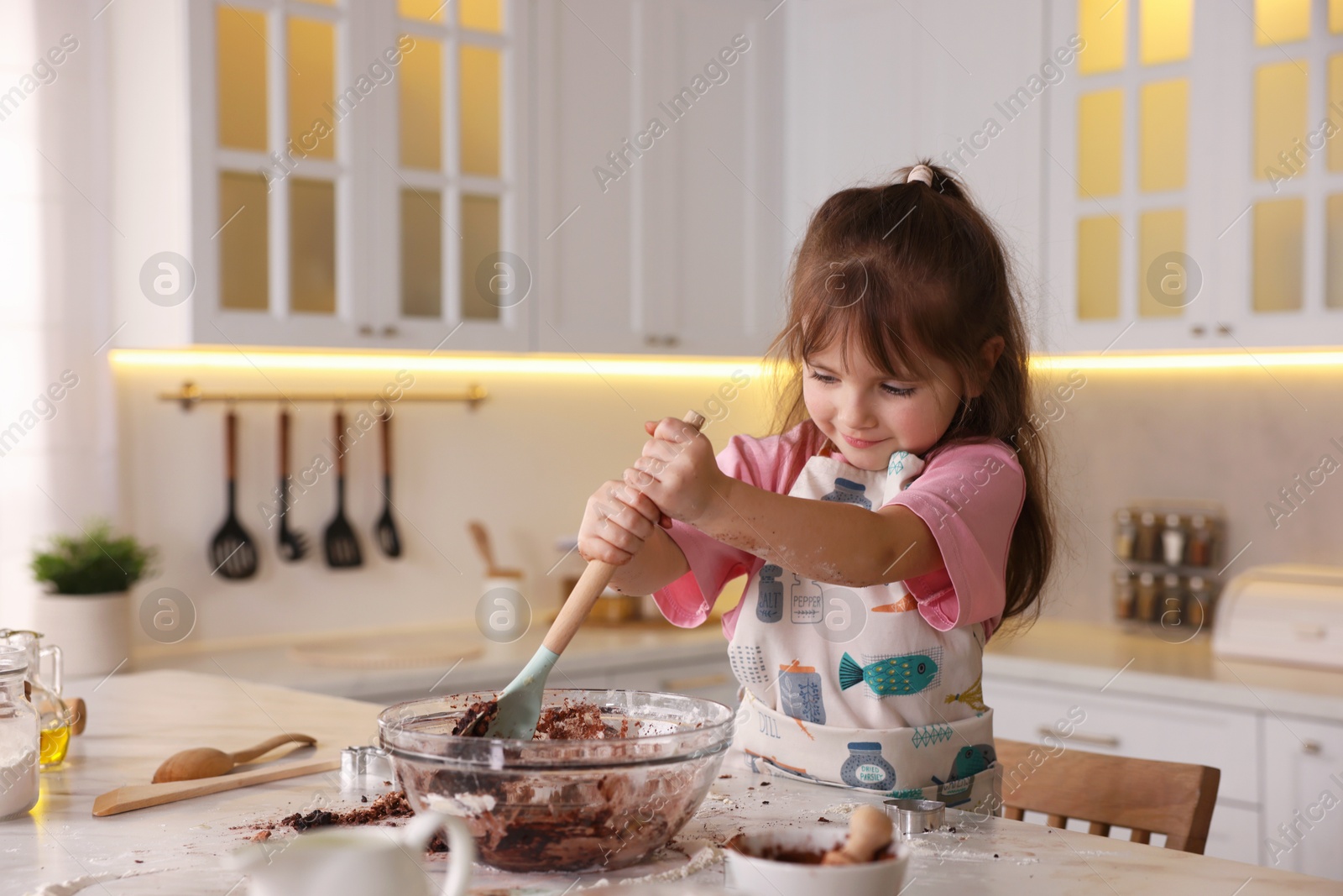 Cooking recipe. Cute girl mixing dough for cookies at table in kitchen. Space for text Photo of Cooking recipe. Cute girl mixing dough for cookies at table in kitchen. Space for text