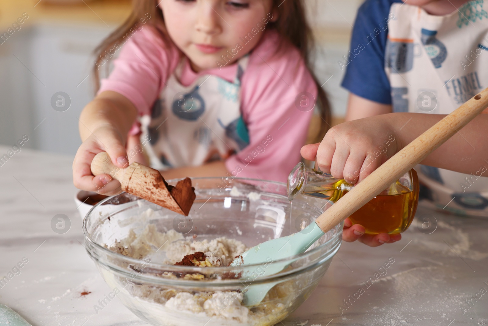 Cooking recipe. Cute children making dough for cookies at table in kitchen, closeup Photo of Cooking recipe. Cute children making dough for cookies at table in kitchen, closeup