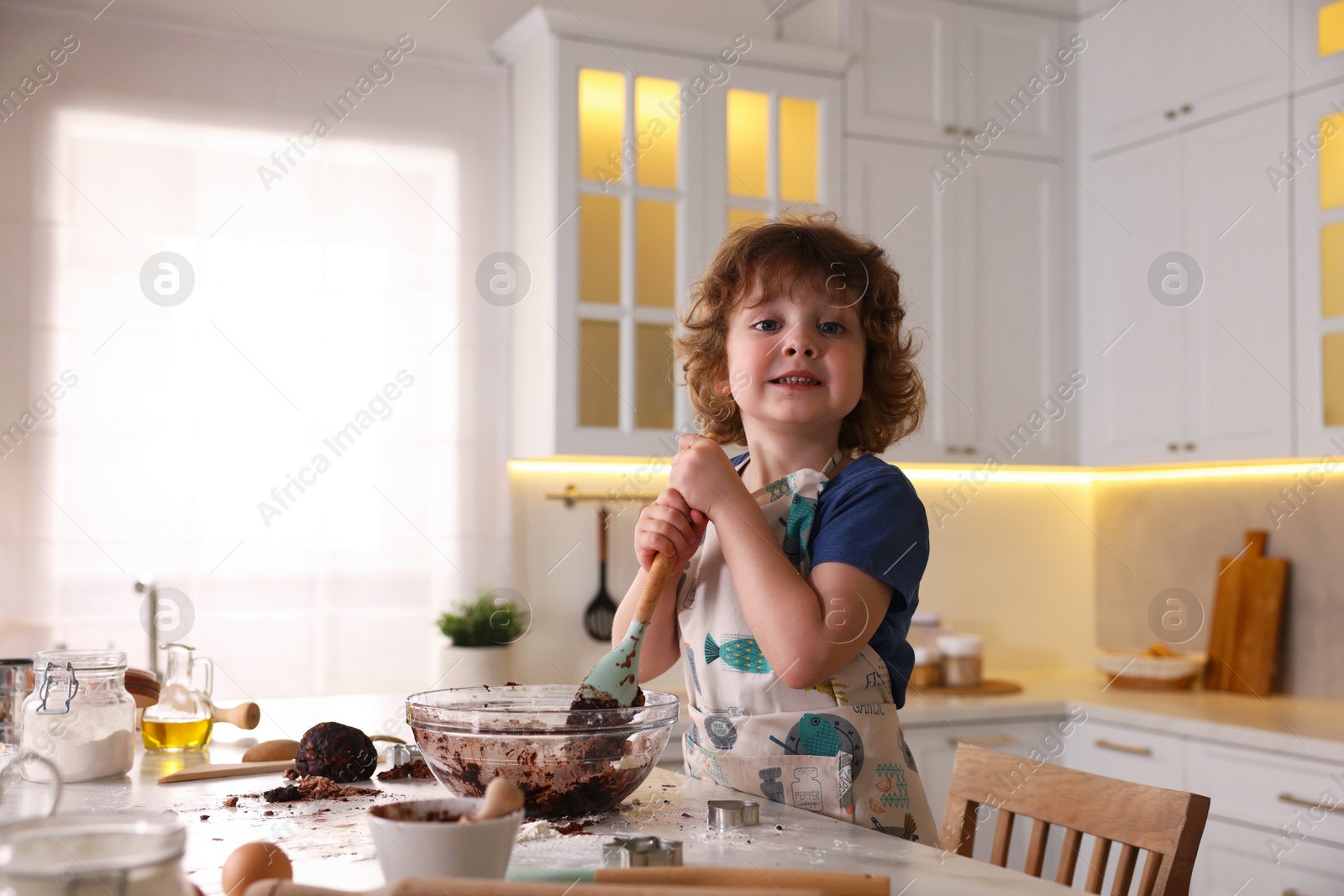 Cooking recipe. Little boy making dough for cookies at table in kitchen. Space for text Photo of Cooking recipe. Little boy making dough for cookies at table in kitchen. Space for text