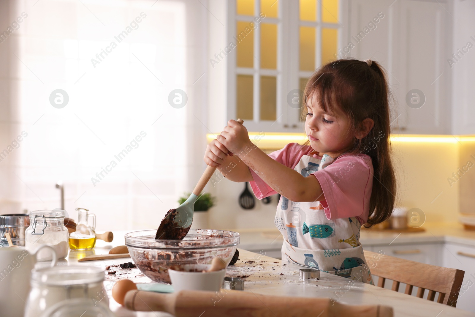 Cooking recipe. Little girl making dough for cookies at table in kitchen. Space for text Photo of Cooking recipe. Little girl making dough for cookies at table in kitchen. Space for text