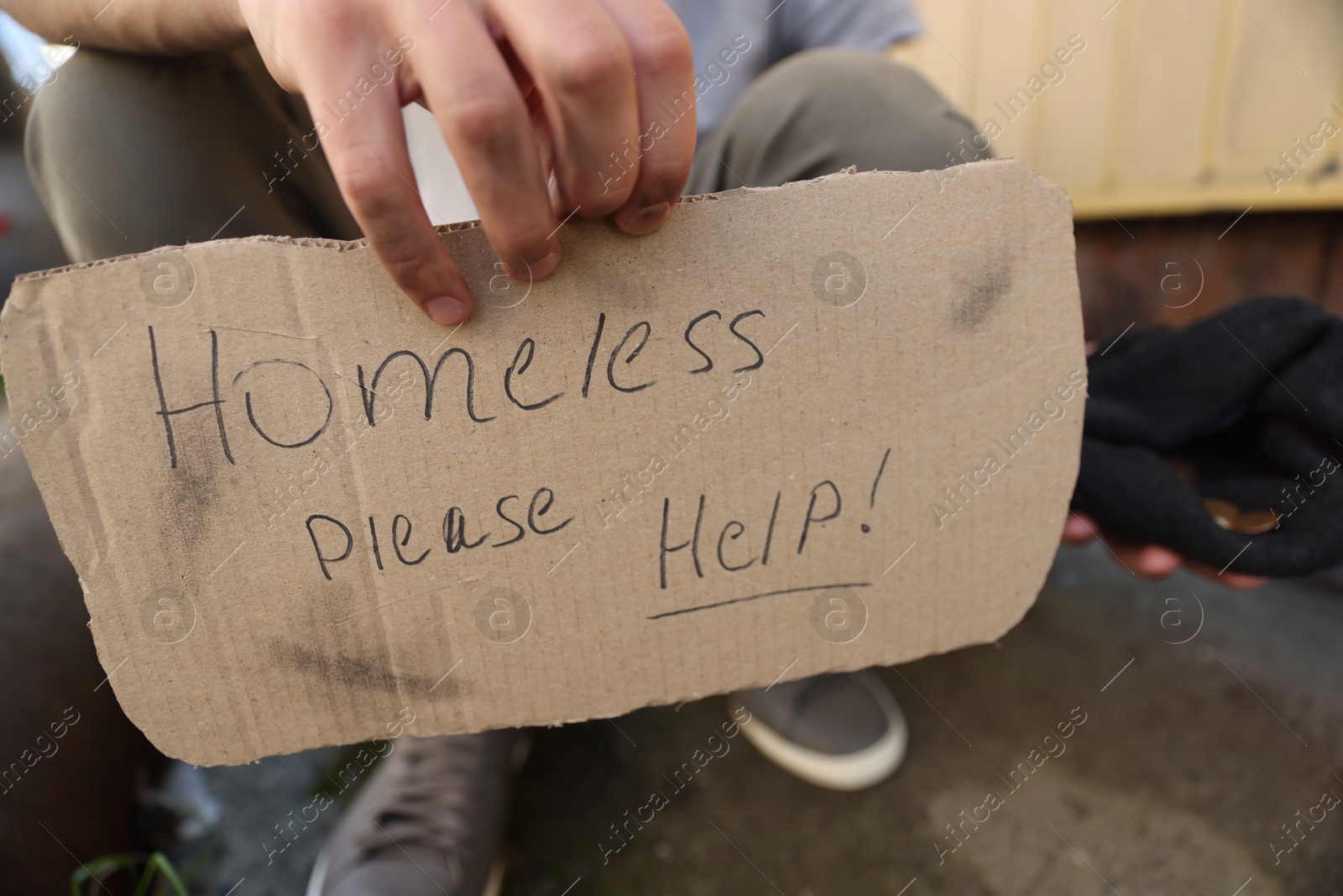 Man with sign Homeless please help and money outdoors, closeup Photo of Man with sign Homeless please help and money outdoors, closeup